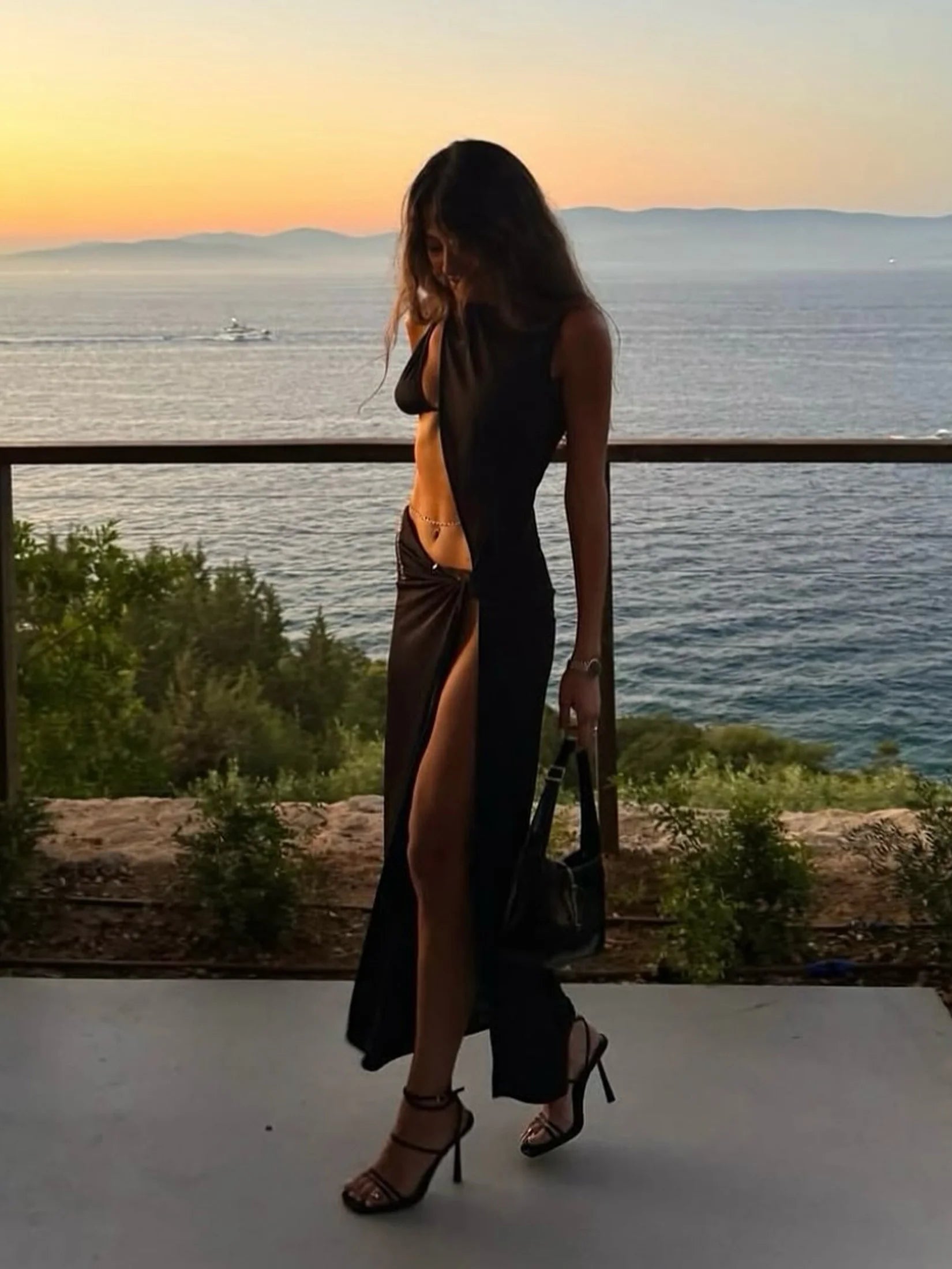 Saída de praia longa usada ao pôr do sol, look feminino ideal para compor com biquíni em dias de verão